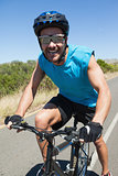 Smiling cyclist riding on the open road
