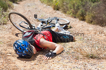 Injured cyclist lying on ground after a crash