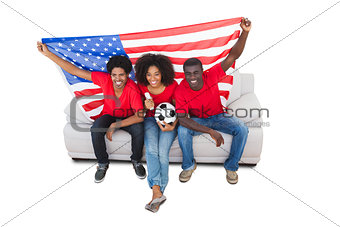 American football fans in red on the sofa