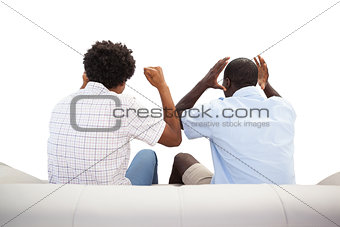 Rival sports fans sitting on the couch
