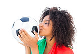 Pretty football fan with portugal flag kissing ball
