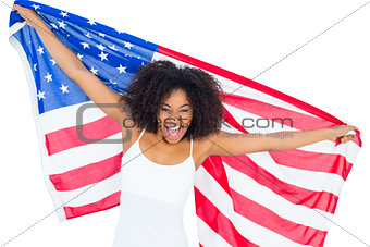 Pretty cheering girl in white top holding american flag
