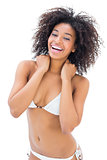 Fit girl in white bikini smiling at camera