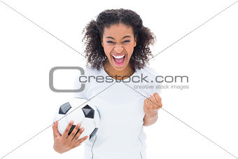 Pretty football fan in white cheering at camera