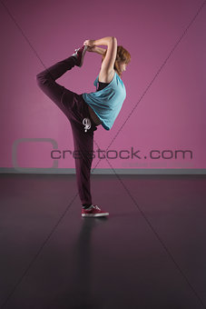Pretty break dancer stretching leg behind head