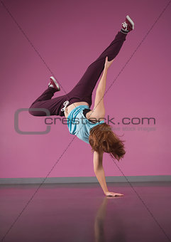 Pretty break dancer doing handstand with one hand