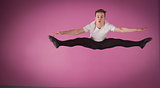 Focused male ballet dancer leaping doing the splits