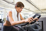 Fit focused brunette working out on the exercise bike
