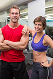 Fit attractive couple smiling at camera