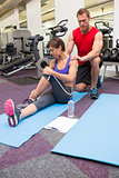 Personal trainer rubbing clients shoulders on mat