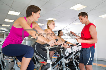 Trainer talking with his spin class