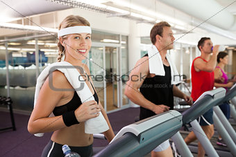 Row of people working out on treadmills