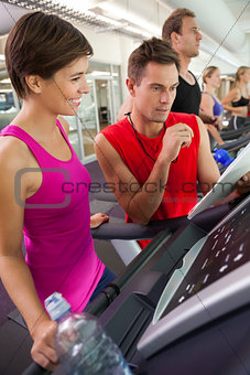 Trainer talking to his client on the treadmill