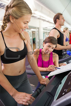 Trainer talking to her client on the treadmill