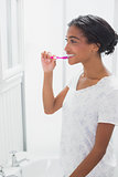 Pretty woman brushing her teeth
