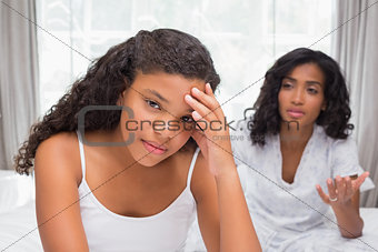 Mother and daughter having an argument on bed