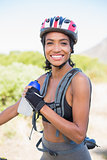Fit woman going for bike ride holding water bottle