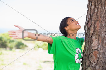 Pretty environmental activist looking up at tree