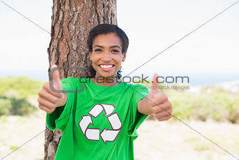 Pretty environmental activist smiling at camera showing thumbs up