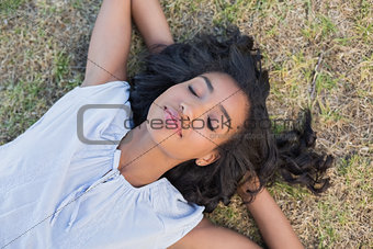 Casual pretty woman napping on the grass