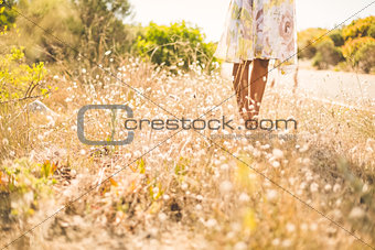 Woman in floral dress standing by the road