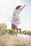 Beautiful woman in floral dress jumping up