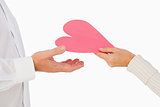 Woman handing man a paper heart