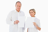 Upset couple holding torn piece of paper