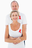 Mature couple supporting aids awareness together