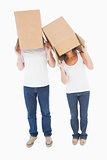 Mature couple wearing boxes over their heads