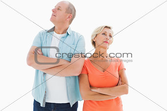 Thinking older couple with arms crossed