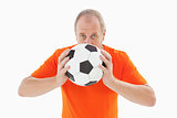 Nervous football fan holding ball