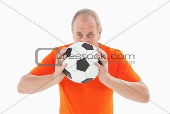 Nervous football fan holding ball