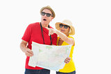 Happy tourist couple using map