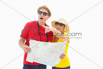 Happy tourist couple using map