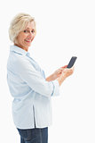 Happy mature woman sending a text