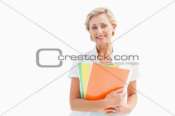 Happy mature student holding notebooks