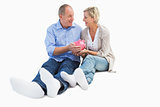 Happy mature couple holding piggy bank