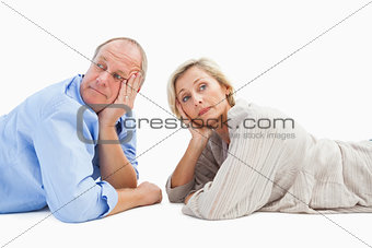 Mature couple lying and thinking
