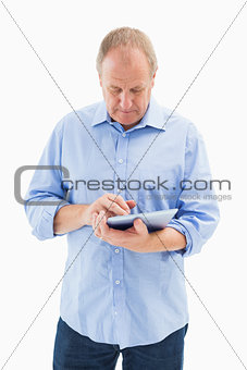 Mature man using his tablet pc