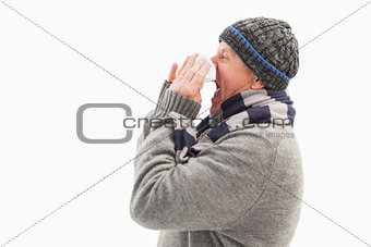 Sick mature man blowing his nose