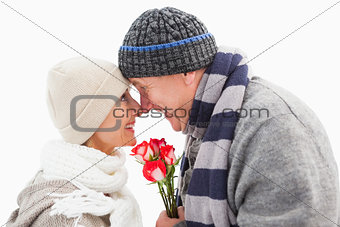 Happy mature couple in winter clothes with roses