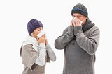 Sick mature couple blowing their noses