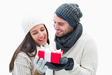 Attractive young couple in warm clothes holding gift