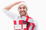 Stressed festive man holding gifts