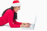 Beautiful festive woman typing on laptop