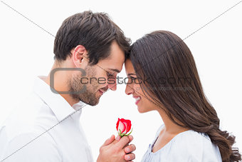 Handsome man offering his girlfriend a rose