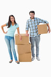 Attractive young couple with moving boxes