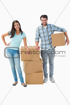 Attractive young couple with moving boxes