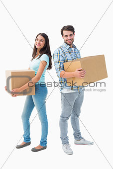 Happy young couple with moving boxes